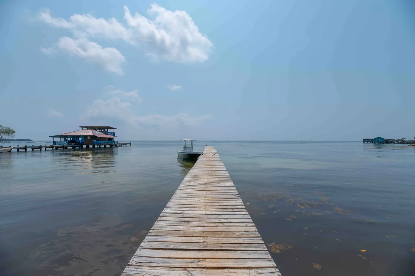 A wooden dock extending into calm water on Saint Helene