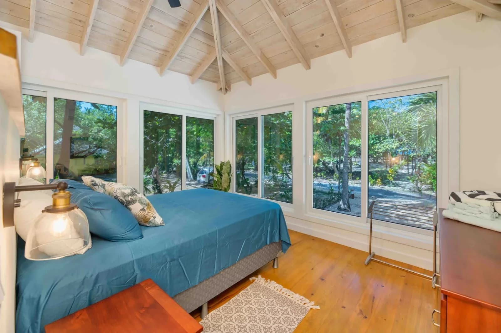 Bright bedroom with forest views at Caulfields Cottage