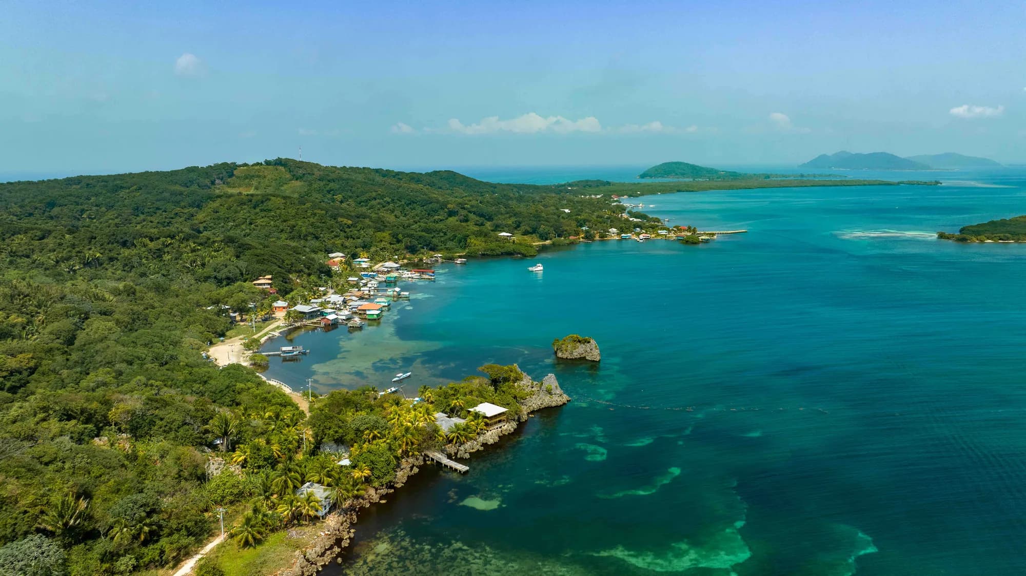 Aerial view of Saint Helene's shoreline, waterfront homes and turquoise Caribbean water
